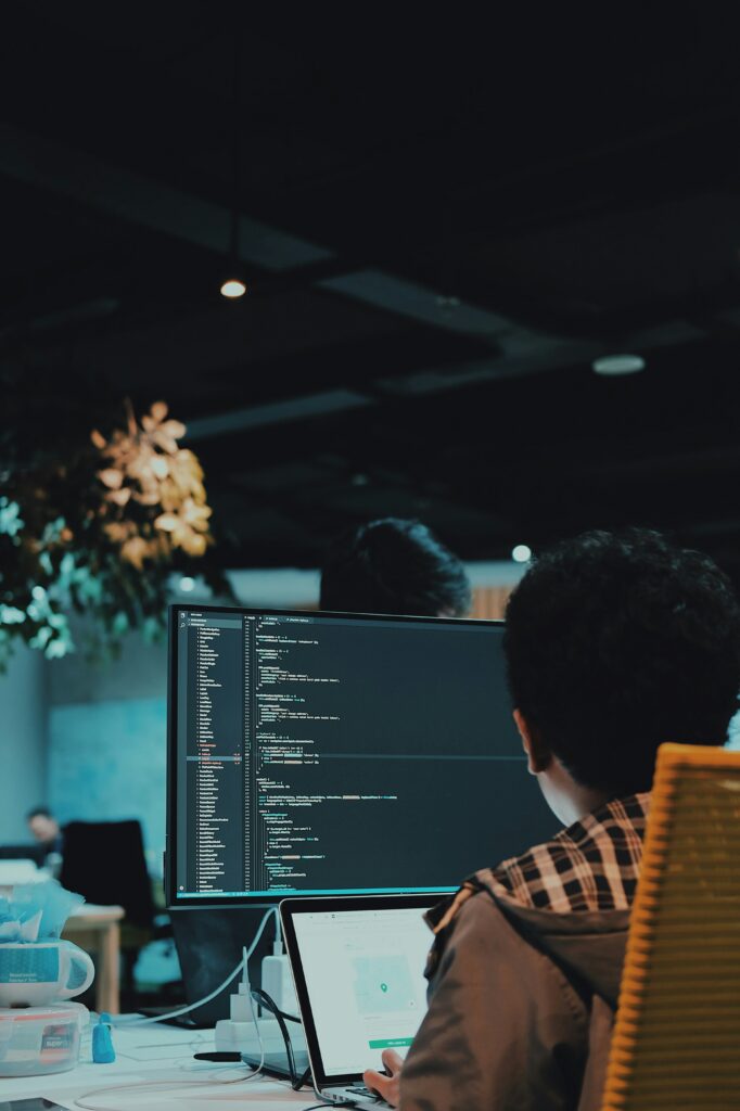 A developer working at a multi-monitor desk
